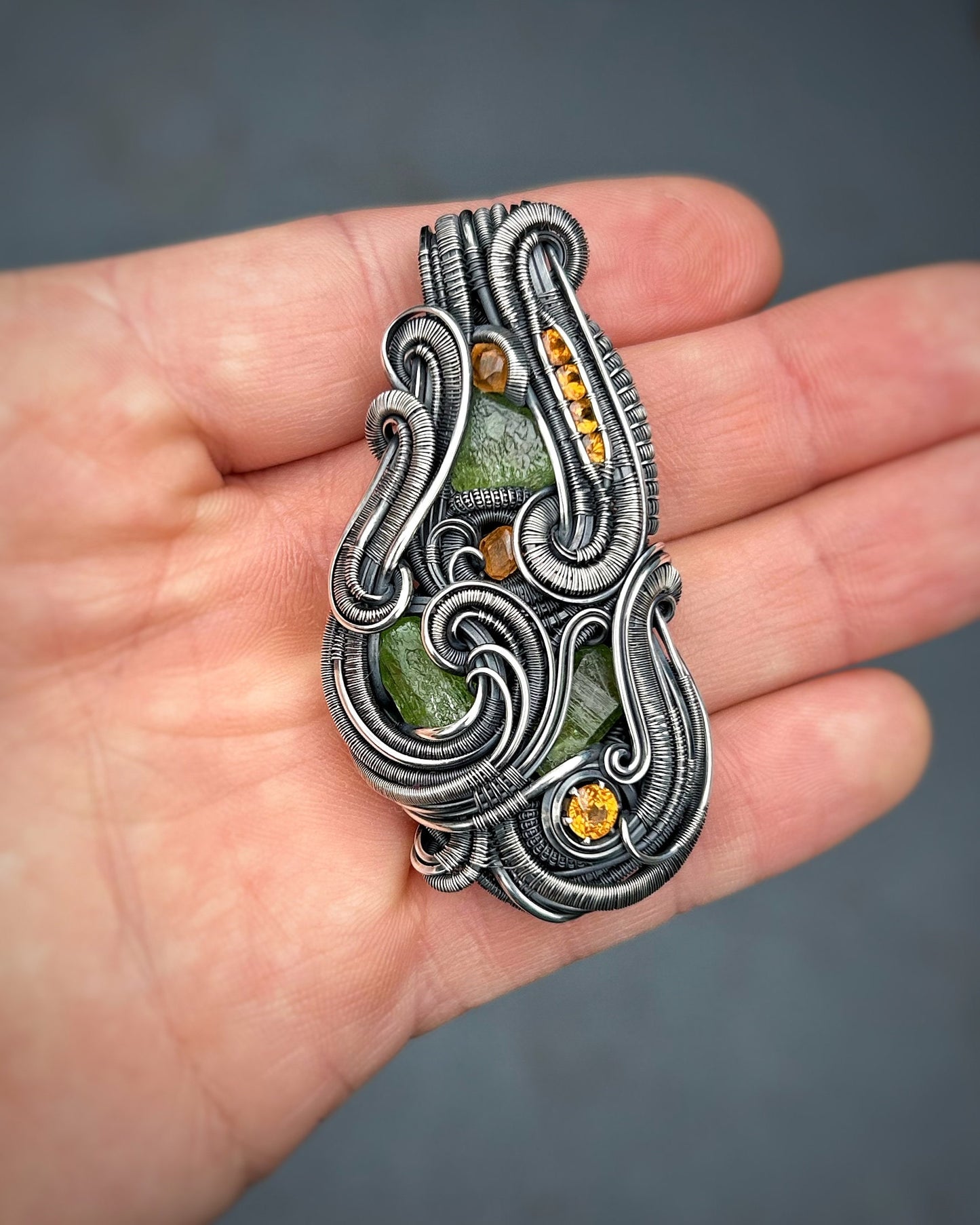 Jungle vibes // peridot // garnets // oxidized silver // festival jewelry // handmade wire art // wire wrap // pendant // flow // sexy wrap