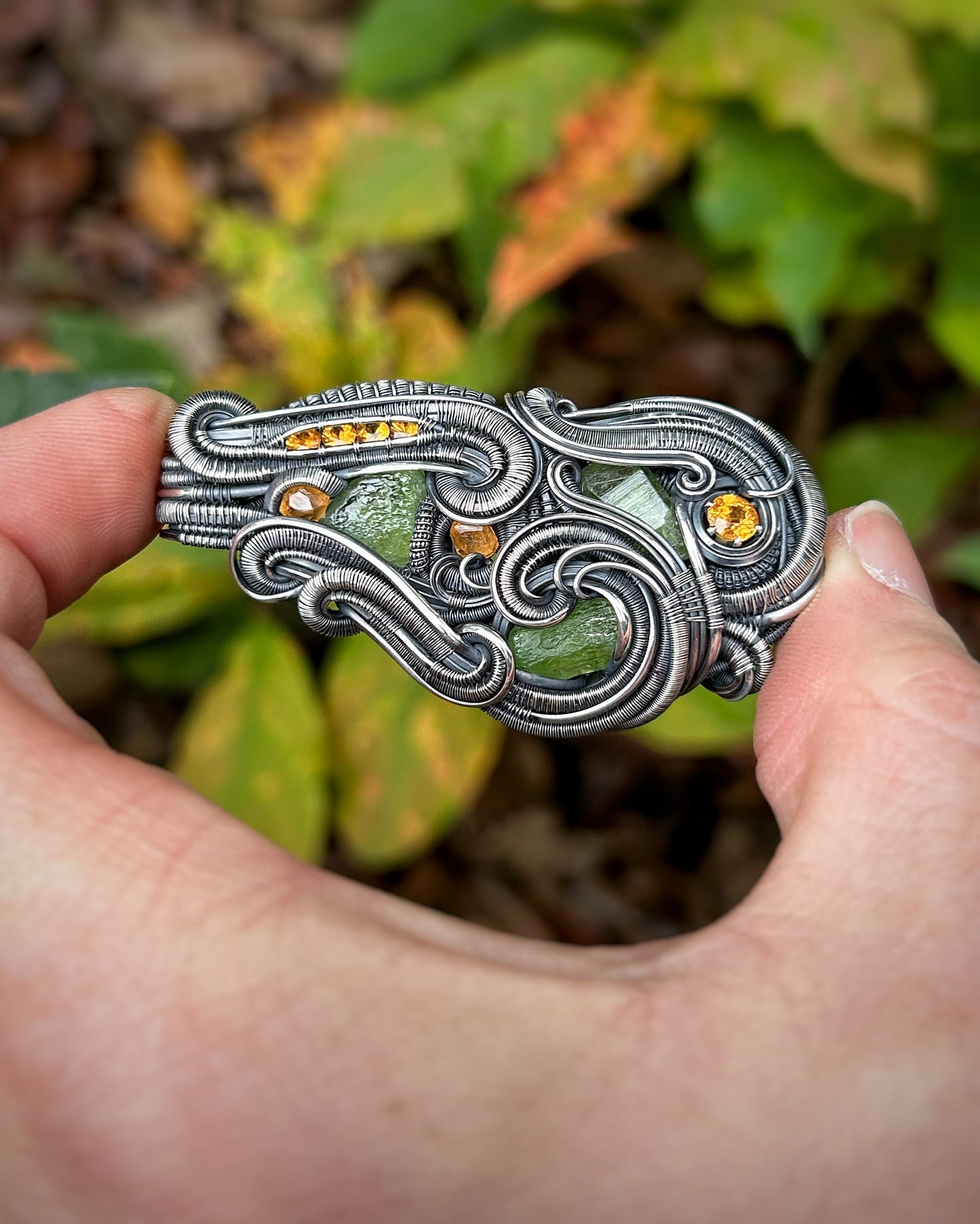 Jungle vibes // peridot // garnets // oxidized silver // festival jewelry // handmade wire art // wire wrap // pendant // flow // sexy wrap