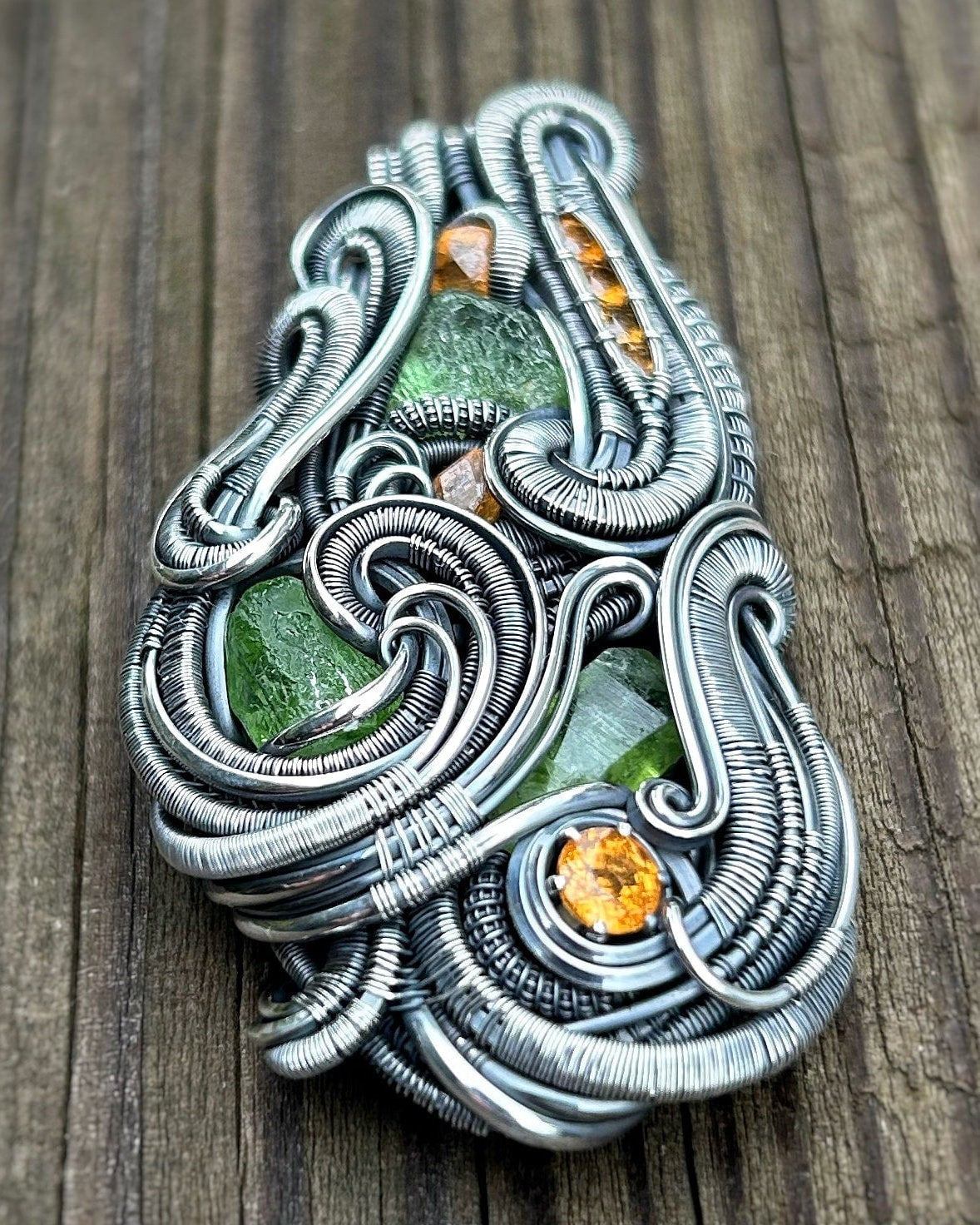 Jungle vibes // peridot // garnets // oxidized silver // festival jewelry // handmade wire art // wire wrap // pendant // flow // sexy wrap