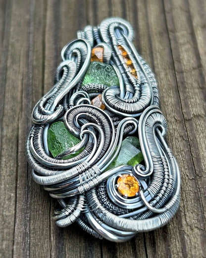 Jungle vibes // peridot // garnets // oxidized silver // festival jewelry // handmade wire art // wire wrap // pendant // flow // sexy wrap