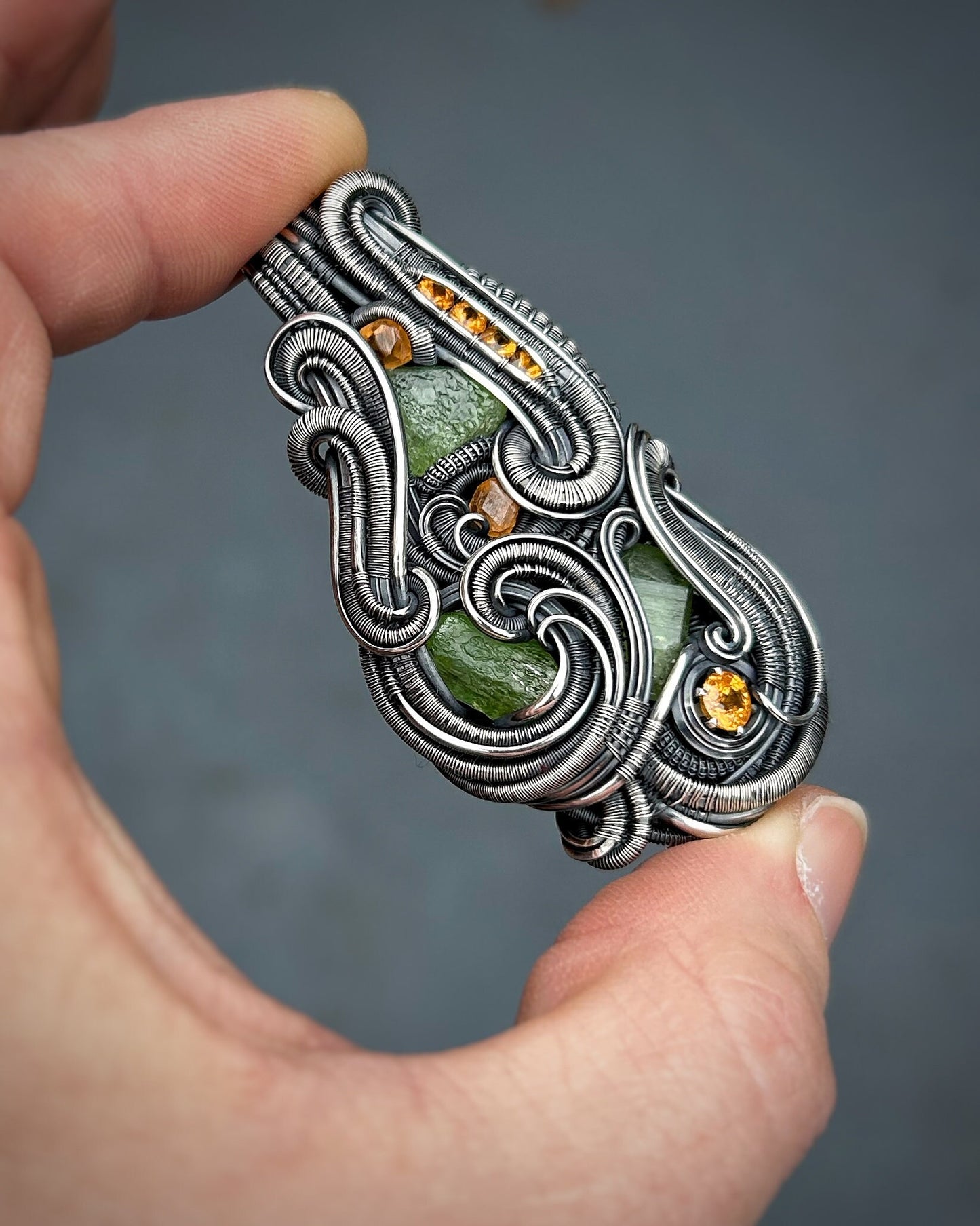 Jungle vibes // peridot // garnets // oxidized silver // festival jewelry // handmade wire art // wire wrap // pendant // flow // sexy wrap